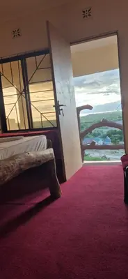 a bedroom with a bed and a window with a red carpet at Eagle Nest lake Natron Lodge in Mtowabaga
