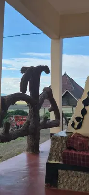 a room with a large window with a sculpture on a bed at Eagle Nest lake Natron Lodge in Mtowabaga