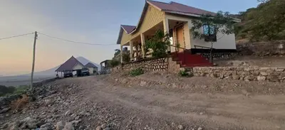 a house on the side of a rocky road at Eagle Nest lake Natron Lodge in Mtowabaga