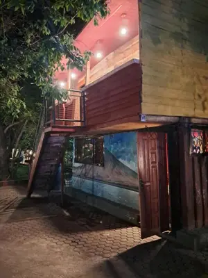 a house with a staircase and a painting on the side of it at Ibrahim Garden Hostel in Arusha
