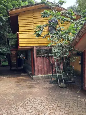 a small house with a ladder in front of it at Ibrahim Garden Hostel in Arusha