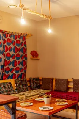 a dining room with a table and a stove at Kilimanjarosons homestay in Moshi