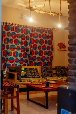 a living room with a couch and a table at Kilimanjarosons homestay in Moshi