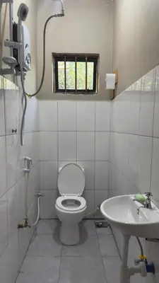 a bathroom with a toilet and a sink at Kilimanjarosons homestay in Moshi