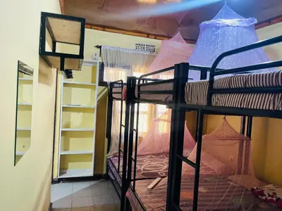 a room with two bunk beds in a room at Amani Homestay in Arusha