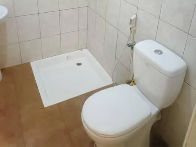 a bathroom with a white toilet in a room at Amani Homestay in Arusha