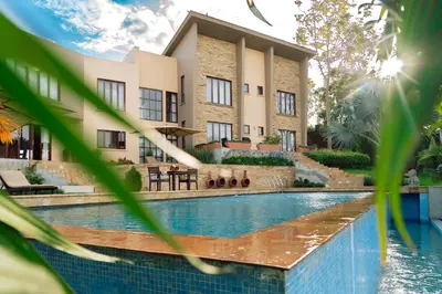 a hotel with a swimming pool in front of a building at The Scenery Residence in Arusha