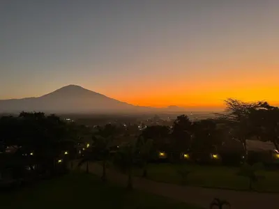 a sunset with a mountain in the background at The Scenery Residence in Arusha