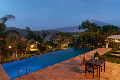 a view of a swimming pool at night at The Scenery Residence in Arusha