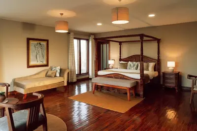 a bedroom with a canopy bed and a couch at The Scenery Residence in Arusha