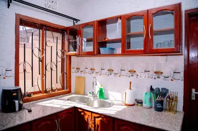 a kitchen with a sink and a window at Hadraj Moshono Apartment1 in Arusha