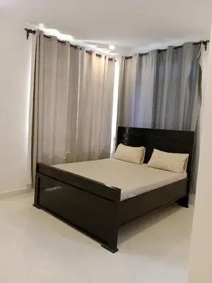 a bed in a room with a large window at Hidalgo Home Apartment's in Moshi