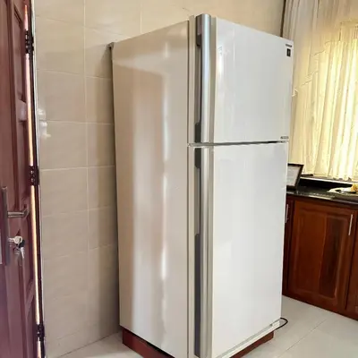 a large white refrigerator in a kitchen at Mercy Apartments Moshi in Uru