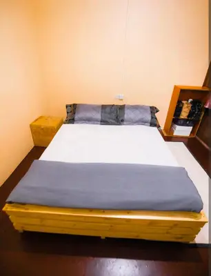 a bed in a room with a blue blanket at New Star House in Arusha