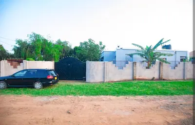 a car parked in front of a fence at New Star House in Arusha