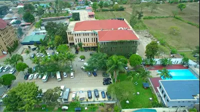 an overhead view of a building with a parking lot at Lush Garden Apartment in Arusha