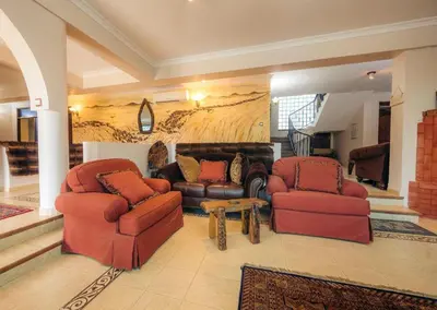 a living room with two chairs and a couch at Gafa House lodge in Sokon