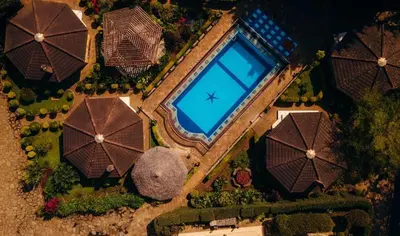 an overhead view of a swimming pool with umbrellas at Gafa House lodge in Sokon