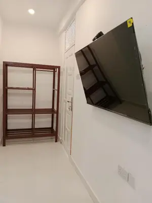 a flat screen tv hanging on a wall in a room at Hidalgo Explorers Home in Moshi