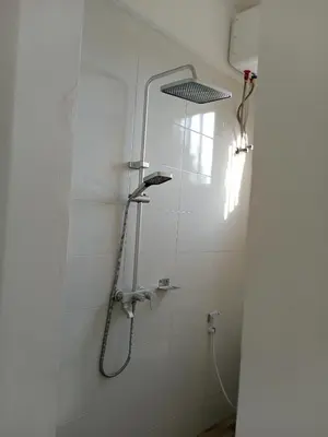 a shower with a shower head in a bathroom at Hidalgo Explorers Home in Moshi