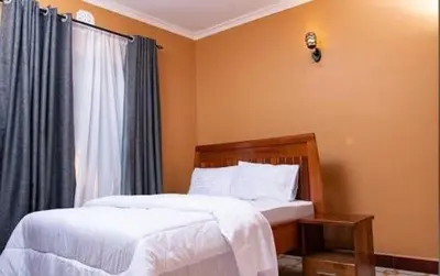 a bedroom with two beds and a window at MSF one bedroom in Arusha