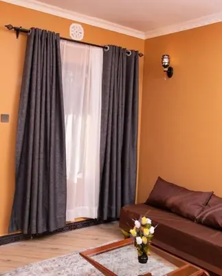 a living room with a couch and a window at MSF one bedroom in Arusha