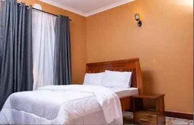 a bedroom with two beds and a window at MSF one bedroom in Arusha