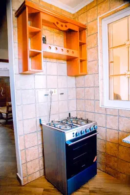 a kitchen with a stove top oven in a room at Rhovee Homes in Moshi