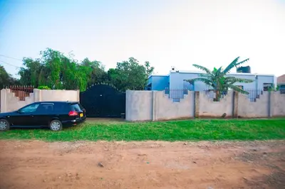 a car parked in a yard next to a fence at Bantulaki House in Arusha