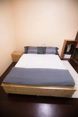 a bedroom with a bed with a blue blanket at Bantulaki House in Arusha