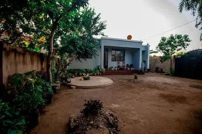 a house with a lot of plants in front of it at Bantulaki House in Arusha