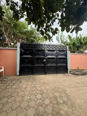 a black gate with a bunch of shelves at The Hut Hostel in Arusha