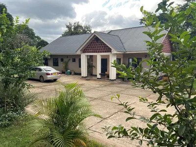 a house with a car parked in front of it at Kiliastra Homes in Moshi