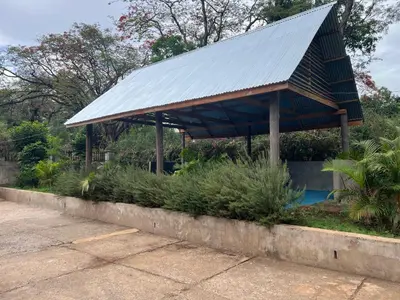 a pavilion with a metal roof next to a pool at Kiliastra Homes in Moshi