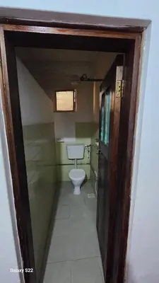 a small bathroom with a toilet in a room at Mardai Homestay in Arusha