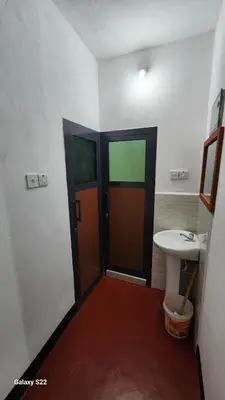 a bathroom with a door and a sink in it at Mardai Homestay in Arusha