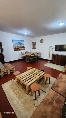 a room with a table and stools and a table and chairs at Mardai Homestay in Arusha