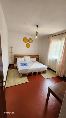 a bedroom with a large bed in a room at Mardai Homestay in Arusha