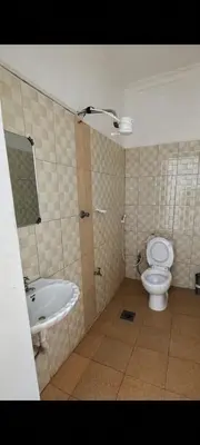 a bathroom with a toilet and a sink at Arusha Sunbird Lodge in Arusha