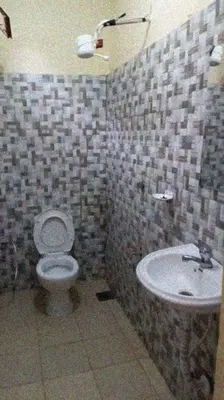 a bathroom with a toilet and a sink at Arusha Sunbird Lodge in Arusha