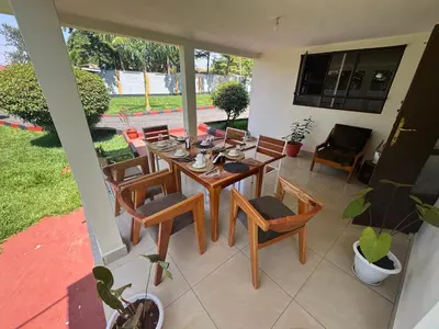 a dining room with a table and chairs at Kivuli Lodge in Moshi
