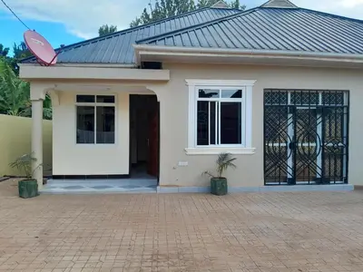 a house with a gate in front of it at STAN LODGE Babati in Babati