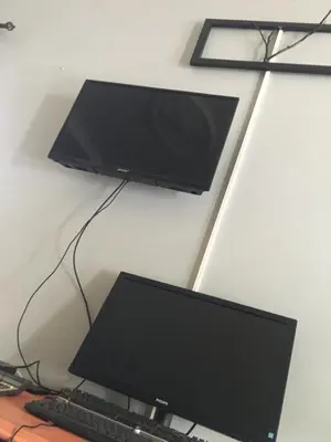 a computer monitor and a keyboard on a desk at Humphrey home stay in Arusha
