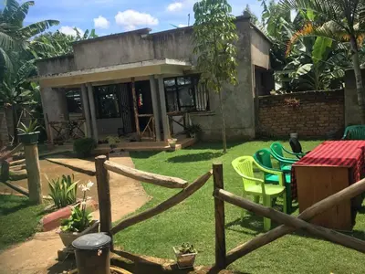 a house with a table and chairs in a yard at Humphrey home stay in Arusha