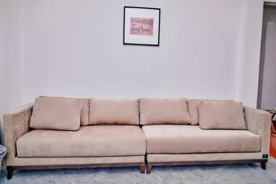 a brown couch sitting in a living room at Lake duluti serenity villas in Arusha