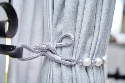 a gray curtain with a rope tied to a door at Lake duluti serenity villas in Arusha