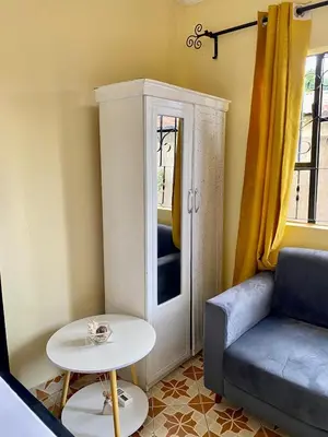 a living room with a couch and a table at Comfort studio apartment in Arusha