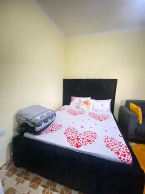 a bedroom with a bed with a bedspread with hearts at Comfort studio apartment in Arusha