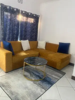 a living room with a couch and a table at Mila home in Arusha