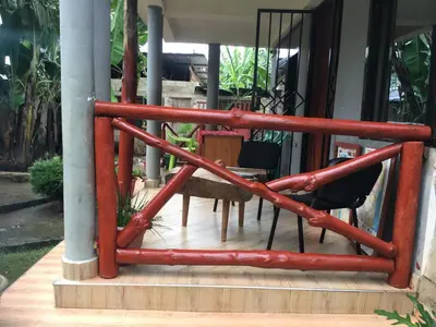 a table and chairs on the porch of a house at Humphrey home stay in Arusha